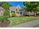 Charming brick home featuring a well-manicured lawn and inviting front porch, perfect for relaxing outdoors at 4731 Moon Chase Dr, Buford, GA 30519