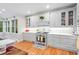 Bright and modern kitchen with white cabinets, herringbone backsplash, and stainless steel appliances at 4731 Moon Chase Dr, Buford, GA 30519