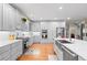Spacious kitchen boasting white cabinets, stainless steel appliances, and hardwood floors at 4731 Moon Chase Dr, Buford, GA 30519