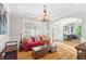 Cozy living room with tray ceilings, hardwood floors, and an abundance of natural light at 4731 Moon Chase Dr, Buford, GA 30519