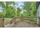 A rustic wooden deck overlooks the lush, green backyard, providing a tranquil outdoor space at 558 Elbridge Nw Dr, Atlanta, GA 30318