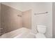 Modest bathroom featuring a tub and shower combination, a toilet and tiled walls at 558 Elbridge Nw Dr, Atlanta, GA 30318