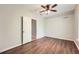 A light and airy bedroom boasts gorgeous wood-look floors and a modern ceiling fan at 558 Elbridge Nw Dr, Atlanta, GA 30318
