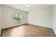 Bright bedroom featuring hardwood floors, a large window, and neutral paint colors at 558 Elbridge Nw Dr, Atlanta, GA 30318