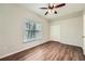 Comfortable bedroom featuring wood floors, a ceiling fan, a window, and a closet at 558 Elbridge Nw Dr, Atlanta, GA 30318