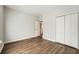 Bedroom featuring hardwood floors, neutral walls, closet space, and a doorway at 558 Elbridge Nw Dr, Atlanta, GA 30318