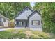 Charming home featuring a quaint front porch and traditional architectural details surrounded by mature trees and manicured lawn at 558 Elbridge Nw Dr, Atlanta, GA 30318