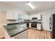 Well-lit kitchen with white cabinets, ample counter space, and modern appliances, perfect for cooking and entertaining guests at 558 Elbridge Nw Dr, Atlanta, GA 30318