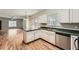 Functional kitchen with white cabinets, ample counter space, stainless steel appliances, and views into the living area at 558 Elbridge Nw Dr, Atlanta, GA 30318