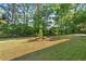 Spacious backyard with lawn and mature trees, great for outdoor activities at 6459 Paula Ct, Rex, GA 30273