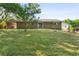 Large backyard with covered carport on brick house with sliding glass door at 6459 Paula Ct, Rex, GA 30273