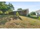 Sloped backyard with patio and view of the rear of the brick house at 6459 Paula Ct, Rex, GA 30273