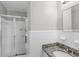 Tiled bathroom featuring a shower, granite-topped vanity, and modern fixtures at 6459 Paula Ct, Rex, GA 30273