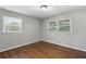 Bright bedroom with hardwood floors and natural light from two windows at 6459 Paula Ct, Rex, GA 30273