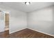 Bedroom with hardwood floors and neutral walls, leading to bathroom at 6459 Paula Ct, Rex, GA 30273