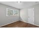 Bedroom with hardwood floors, natural light, and neutral-colored walls at 6459 Paula Ct, Rex, GA 30273