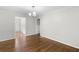 Cozy dining room with hardwood floors, soft gray walls and a modern chandelier at 6459 Paula Ct, Rex, GA 30273