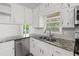 Well-lit kitchen featuring granite countertops, stainless steel appliances, and white cabinetry at 6459 Paula Ct, Rex, GA 30273