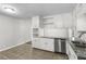 Bright kitchen featuring white cabinets, granite countertops, and stainless steel appliances at 6459 Paula Ct, Rex, GA 30273