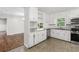 Well-lit kitchen with white cabinets, stainless steel appliances, and modern countertops at 6459 Paula Ct, Rex, GA 30273