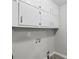 Laundry hookups with white cabinets at 6459 Paula Ct, Rex, GA 30273
