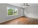 Bright living room featuring hardwood floors, a ceiling fan and large window at 6459 Paula Ct, Rex, GA 30273