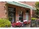 Charming brick building with a small patio, adorned with vibrant flowers and greenery at 791 Wylie Se St # 911, Atlanta, GA 30316
