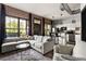 Open-concept living area with exposed brick and modern furnishings and kitchen at 791 Wylie Se St # 911, Atlanta, GA 30316
