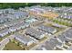 Aerial view of the community featuring modern townhomes, swimming pool, and roundabout intersection at 1117 Larkin Dr, Buford, GA 30518