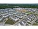 Overview of the new townhome community featuring well-manicured landscaping and tree lined streets at 1117 Larkin Dr, Buford, GA 30518