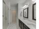 Elegant bathroom featuring double vanity, framed mirrors, and glass shower with subway tile surround at 1117 Larkin Dr, Buford, GA 30518