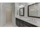 Modern bathroom showcasing double vanity, framed mirrors, stylish lighting, and marble flooring at 1117 Larkin Dr, Buford, GA 30518