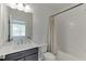 A bathroom with white subway tile, dark vanity, and modern fixtures at 1117 Larkin Dr, Buford, GA 30518