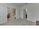 A neutral bedroom with open doors showing staircase and adjoining bathroom at 1117 Larkin Dr, Buford, GA 30518