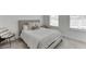 Cozy bedroom with neutral decor, comfortable bed, carpet, and two windows offering ample light at 1117 Larkin Dr, Buford, GA 30518