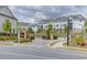 The entrance to the Millcroft community with meticulously maintained landscaping and white townhomes at 1117 Larkin Dr, Buford, GA 30518