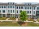 Charming new construction townhome featuring white brick facade and well-manicured front yard at 1117 Larkin Dr, Buford, GA 30518