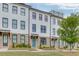 Row of painted brick townhouses with manicured lawns and sidewalks at 1117 Larkin Dr, Buford, GA 30518