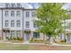 Charming townhome boasts a painted brick facade, large windows, and well-maintained landscaping at 1117 Larkin Dr, Buford, GA 30518
