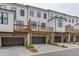 Charming townhomes featuring brick garages, decks, and modern architectural details at 1117 Larkin Dr, Buford, GA 30518