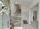 Bright foyer with staircase, light wood floors, and entry to powder room at 1117 Larkin Dr, Buford, GA 30518