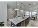 Kitchen island featuring a stainless steel dishwasher, bar stool seating, and views to the living space at 1117 Larkin Dr, Buford, GA 30518