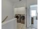 Laundry closet with side-by-side washer and dryer, and wood flooring at 1117 Larkin Dr, Buford, GA 30518