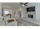 Bright living room featuring a modern fireplace, ceiling fan, and comfortable sectional sofa at 1117 Larkin Dr, Buford, GA 30518