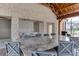 Spacious outdoor kitchen featuring marble countertops and large dining table with seating at 1117 Larkin Dr, Buford, GA 30518