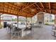 Inviting outdoor lounge featuring stone fireplace, ceiling fans, and dining with seating next to the community pool at 1117 Larkin Dr, Buford, GA 30518