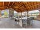 Outdoor seating area with stone fireplace and large island featuring multiple bar stools at 1117 Larkin Dr, Buford, GA 30518