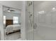 Modern shower with glass enclosure, subway tile, and adjacent bedroom with fan at 1117 Larkin Dr, Buford, GA 30518