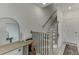 A modern staircase with wood railing and black spindles, leading to the upper level at 1117 Larkin Dr, Buford, GA 30518