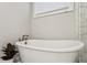 Beautiful soaking tub with elegant fixtures and decorative tile accents at 2023 Yellow Finch Trl, Atlanta, GA 30316